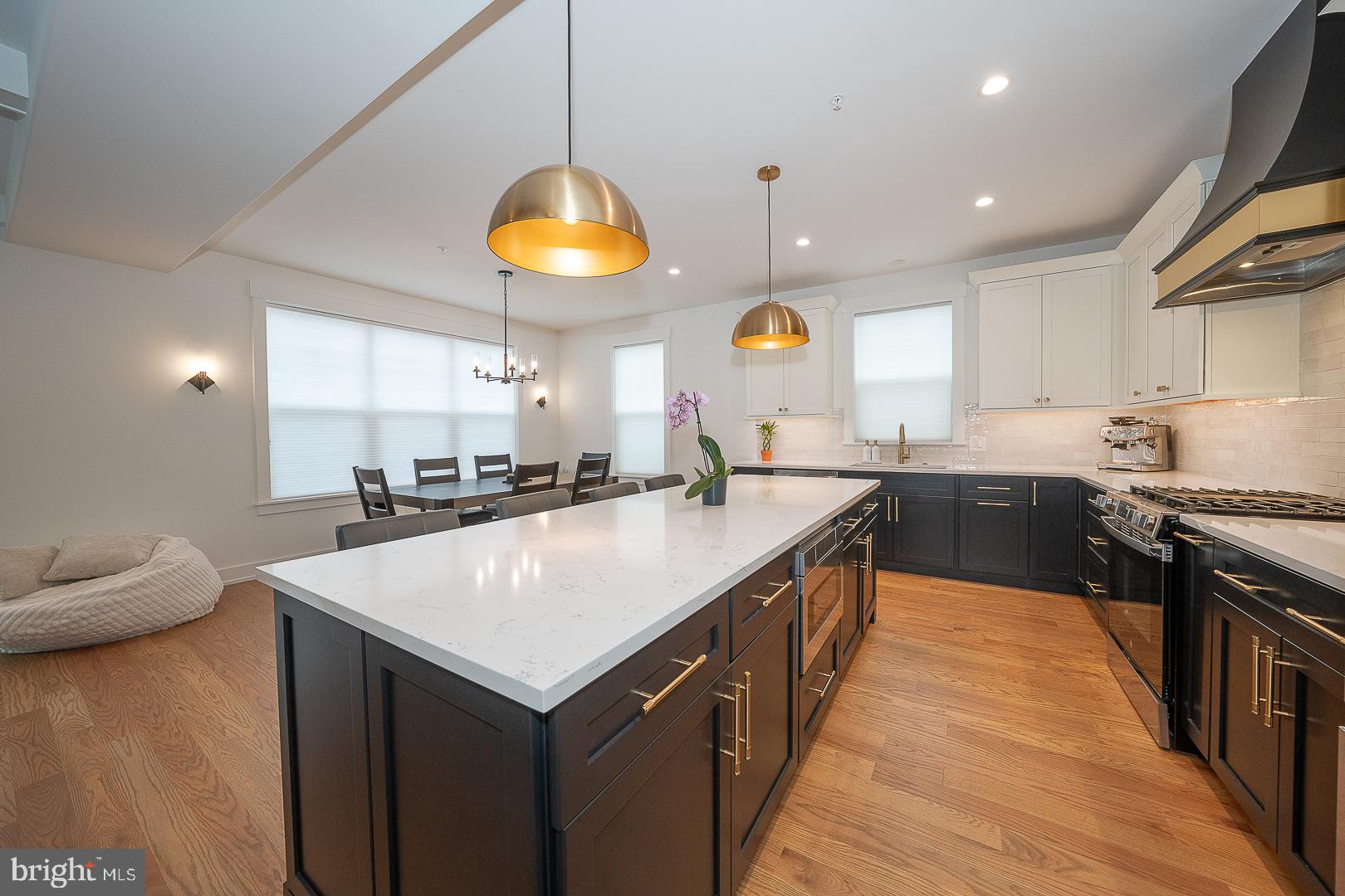 217 Namar Avenue Exton, PA 19341 - Photo 30 of 85 a kitchen with stainless steel appliances granite countertop a sink a stove and a wooden floors