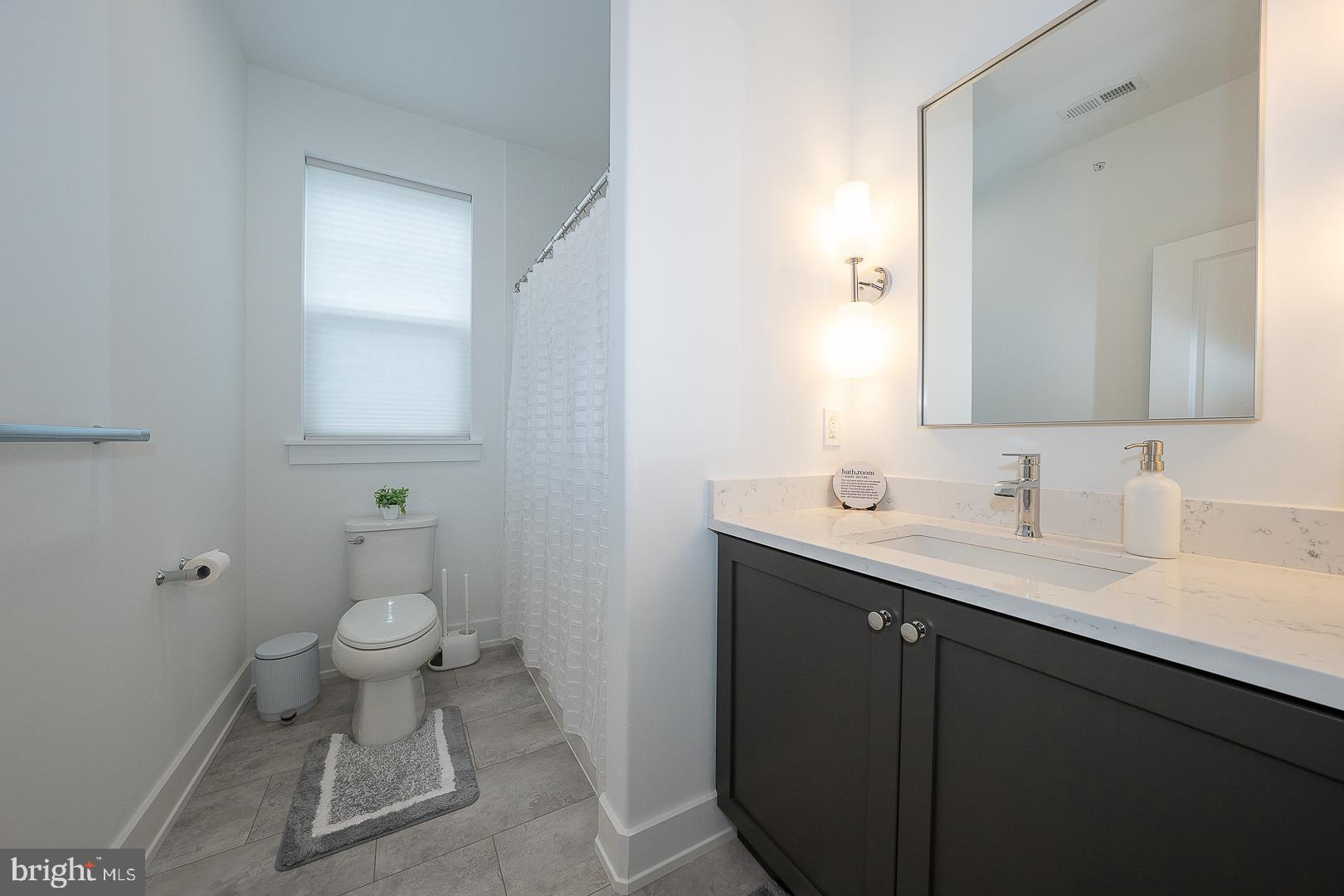 217 Namar Avenue Exton, PA 19341 - Photo 50 of 85 a bathroom with a sink toilet and a mirror