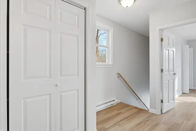 a white toilet sitting next to a shower curtain