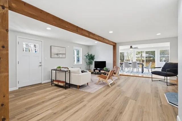a living room with furniture potted plant and a window