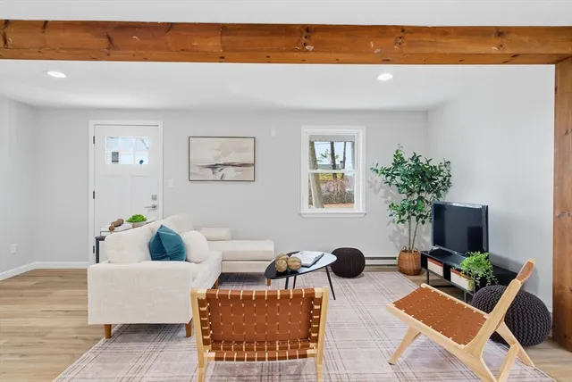 a view of a room with wooden floor and white walls