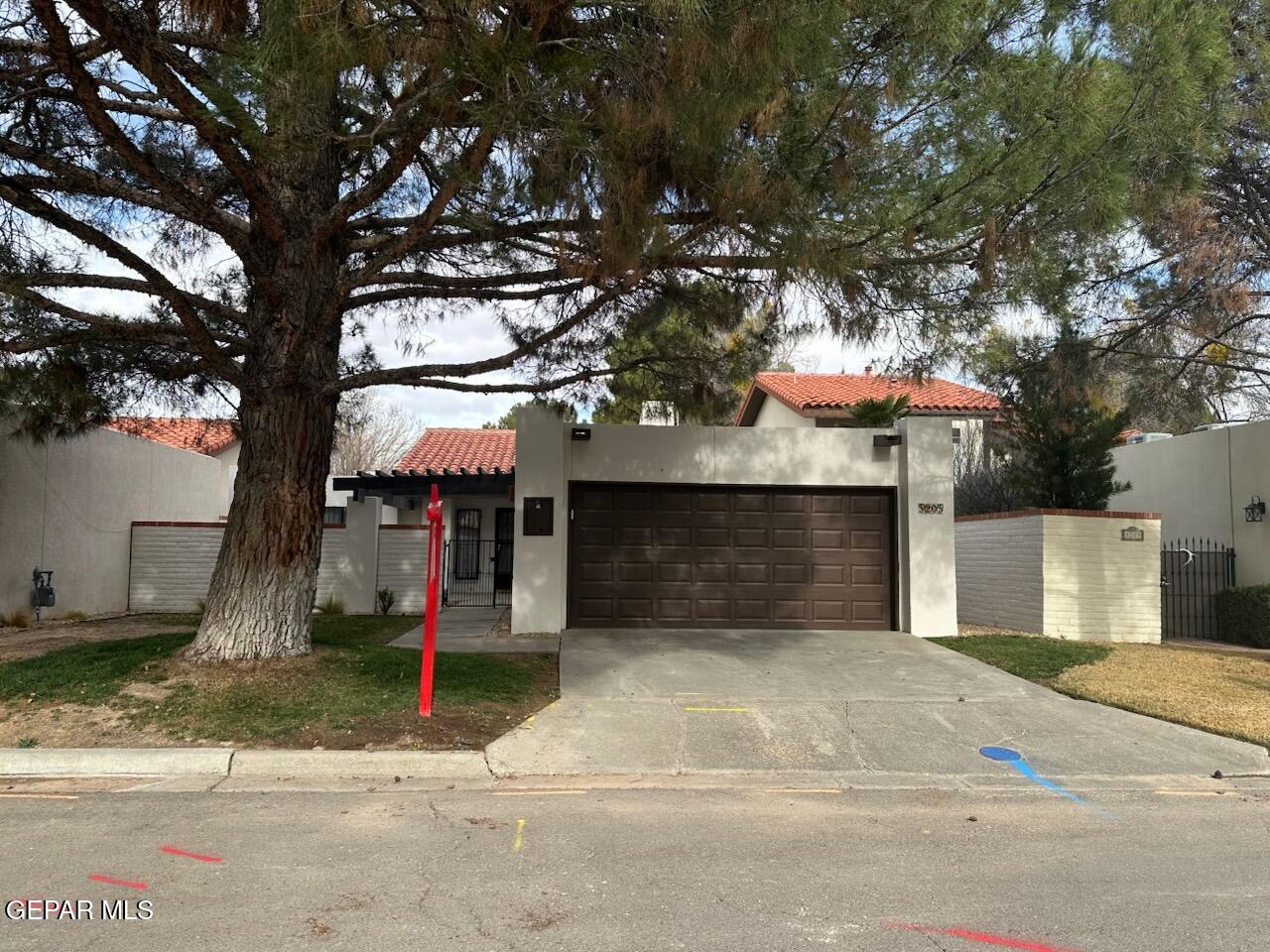 5205 Valley Spring Way El Paso, TX 79932 - Photo 1 of 1 a front view of a house with a yard and garage