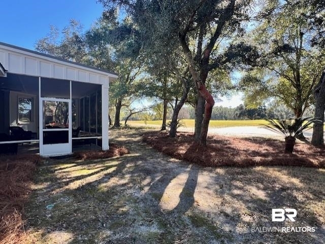 404 Peninsula Boulevard Gulf Shores, AL 36542 - Photo 44 of 51 View of yard featuring a sunroom