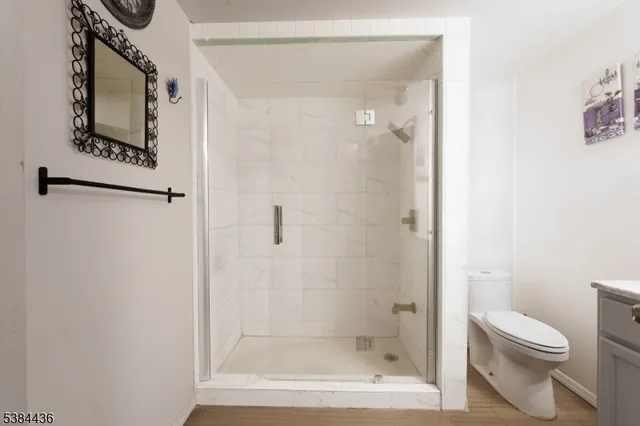 a bathroom with a shower a toilet and a sink