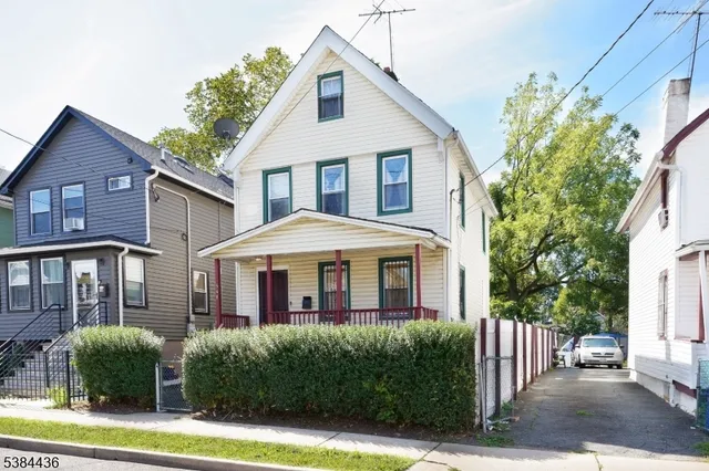 a front view of a house with yard and porch