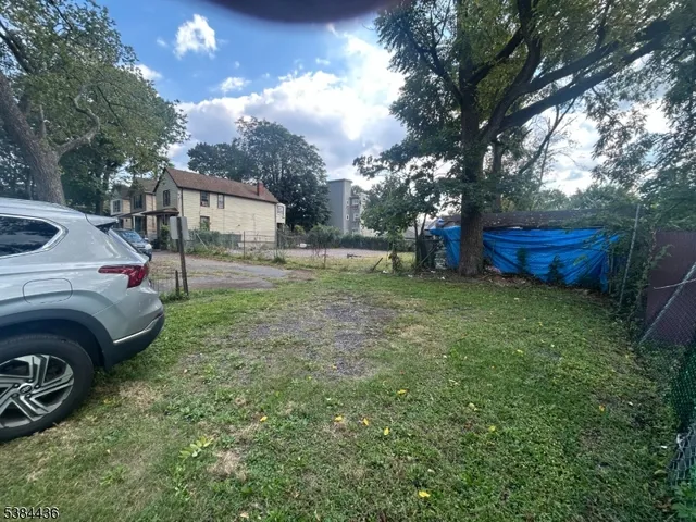 a view of a backyard with a garden and trees