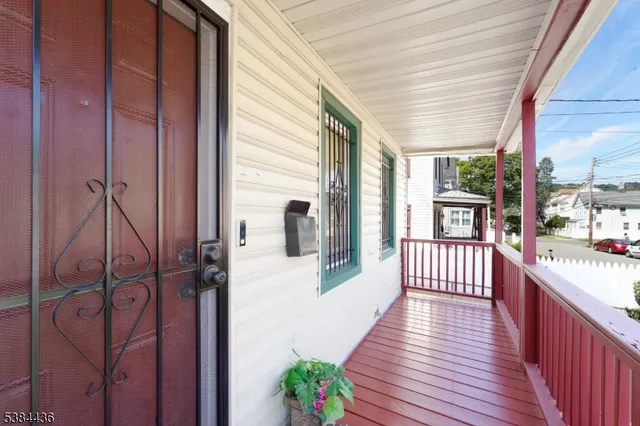 a view of a porch with wooden floor and furniture