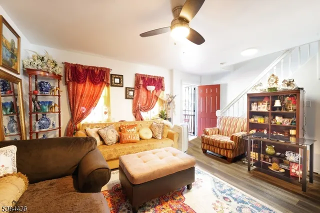 a bedroom with furniture and a large window