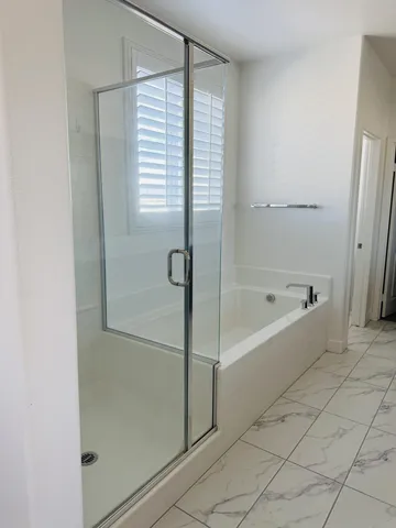 a bathroom with a bathtub and a shower