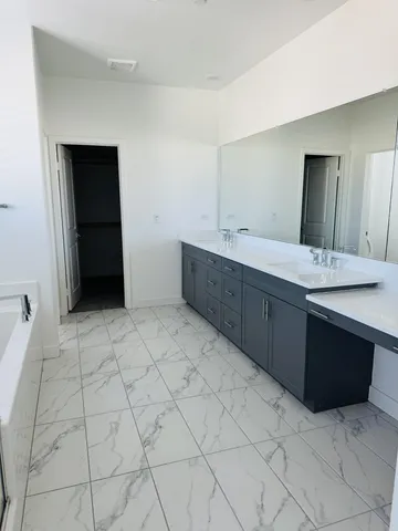 a bathroom with a sink vanity and mirror