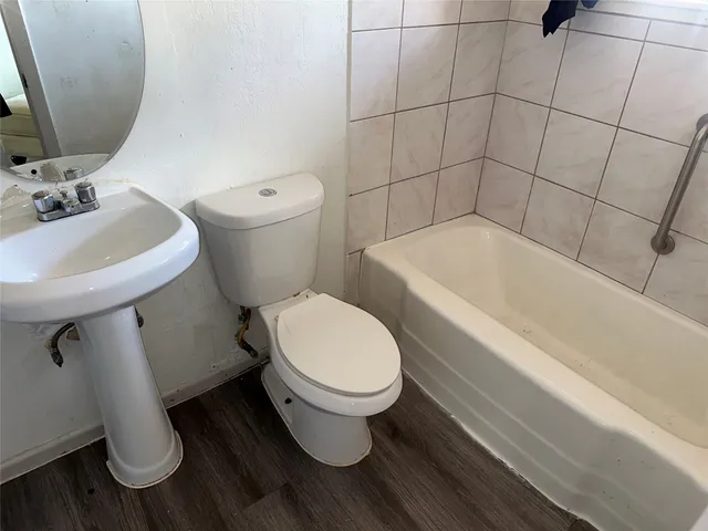 a white toilet sitting next to a bathroom sink