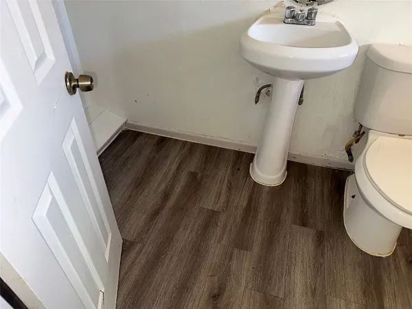 a bathroom with a sink toilet and a mirror