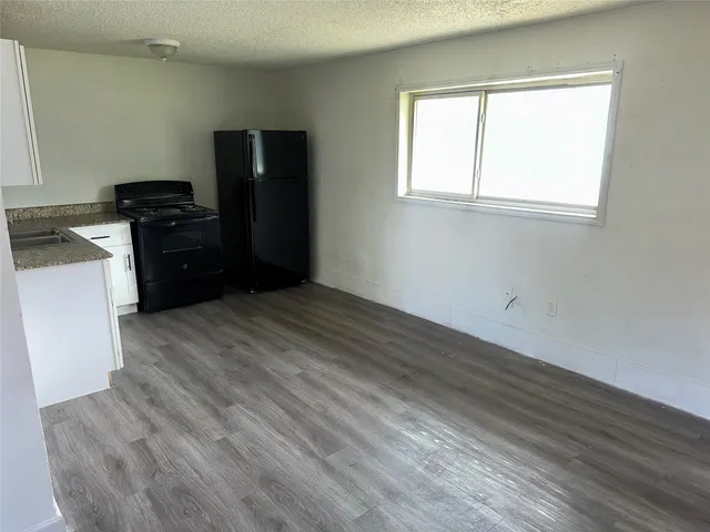 a kitchen with a refrigerator and a stove