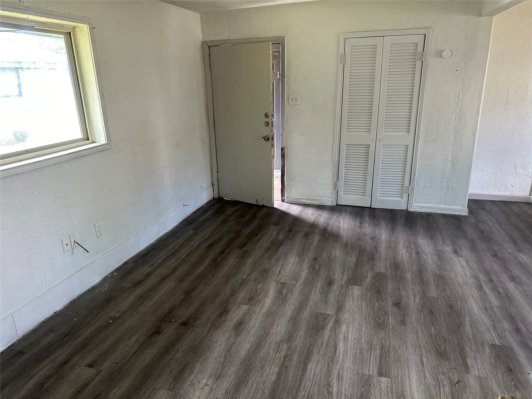 5405 Suez Street, Unit 2 Houston, TX 77020 - Photo 4 of 17 a view of an empty room with wooden floor and a window