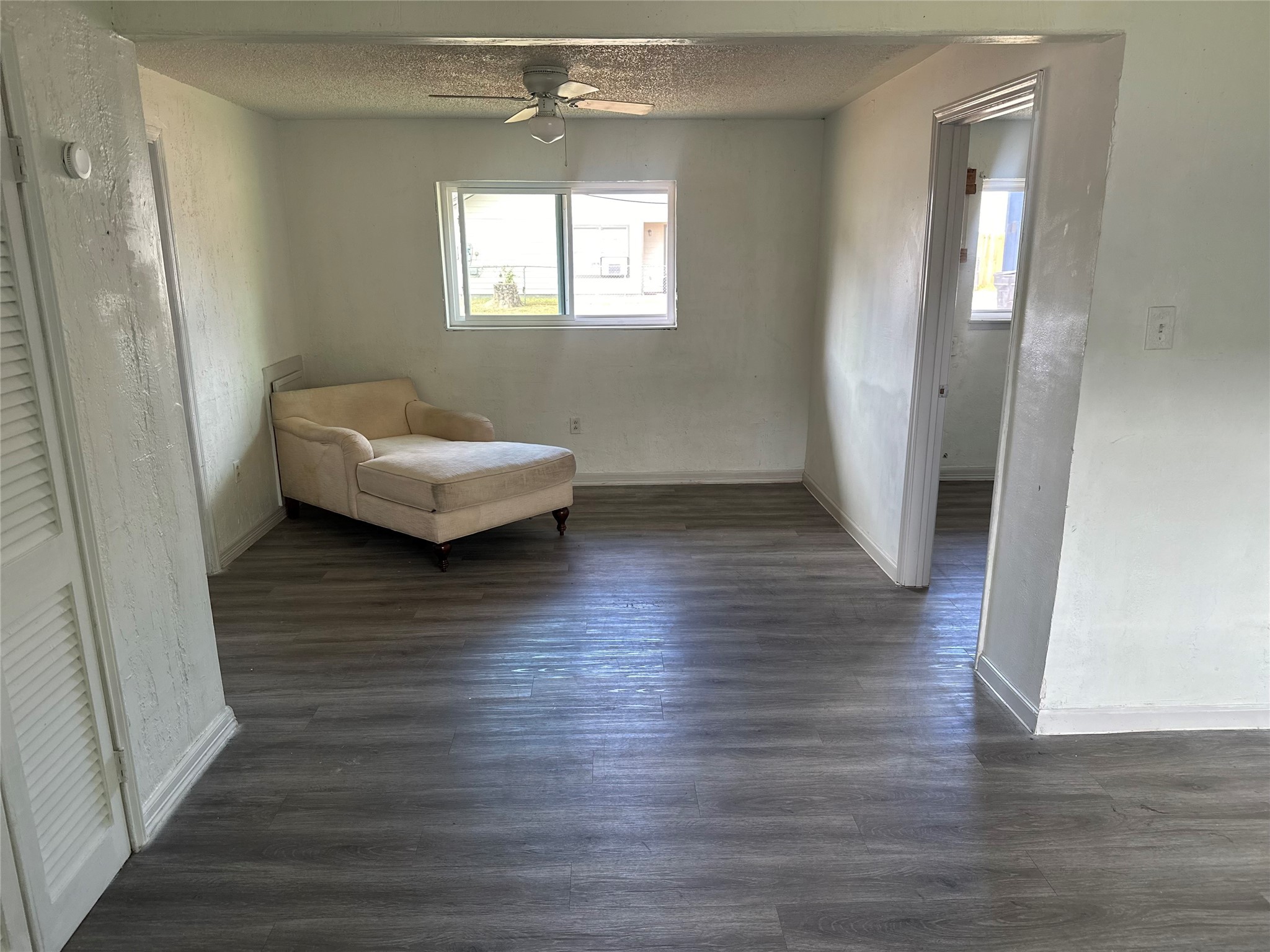 5405 Suez Street, Unit 2 Houston, TX 77020 - Photo 6 of 17 an empty room with wooden floor and windows