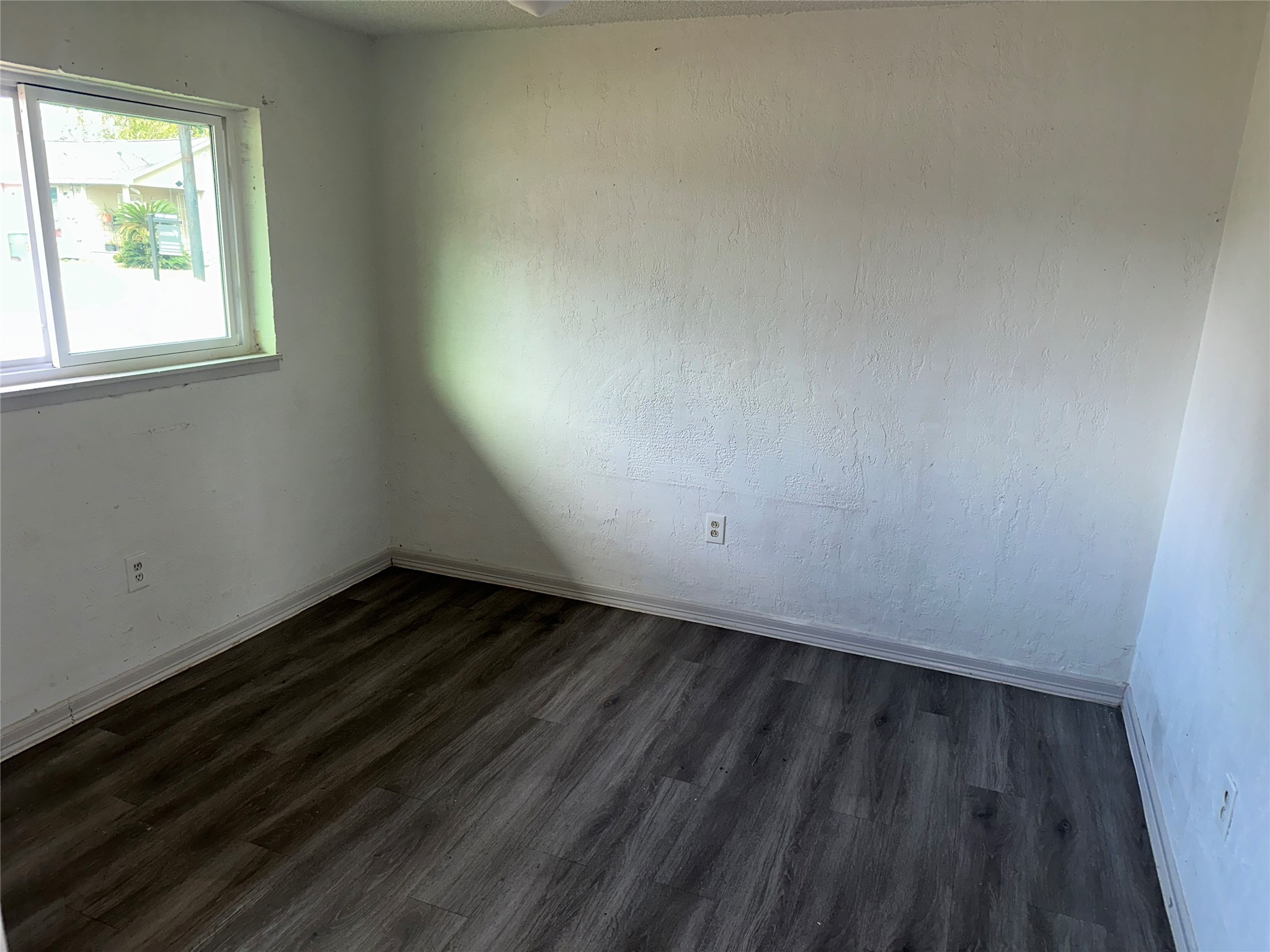 5405 Suez Street, Unit 2 Houston, TX 77020 - Photo 10 of 17 an empty room with wooden floor and windows