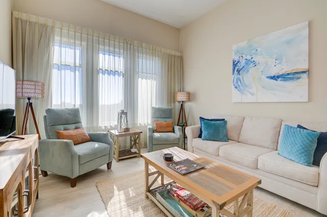 a living room with furniture a rug and a large window