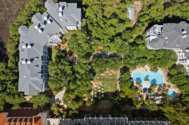 an aerial view of a house with a yard and garden