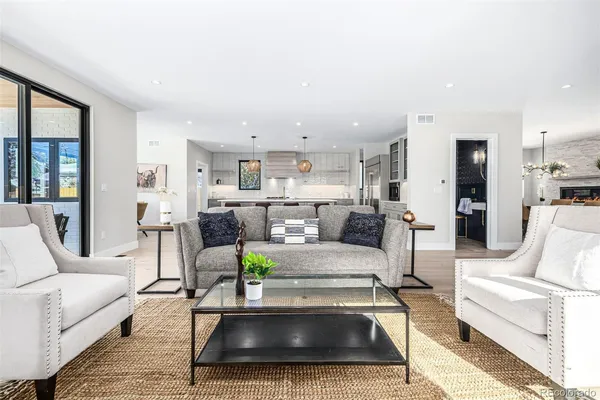 a living room with furniture and a dining table with kitchen view
