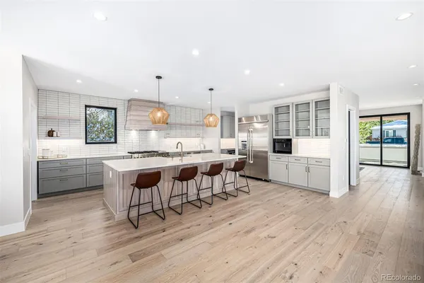 a kitchen with table chairs sink and cabinets
