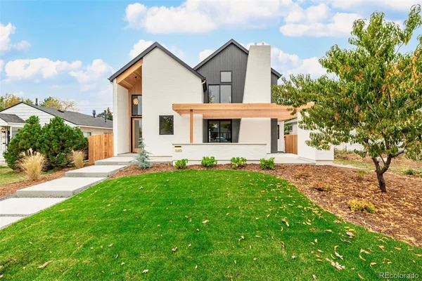a front view of a house with yard and green space