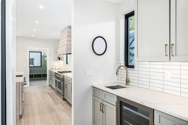 a kitchen with a sink stove and cabinets