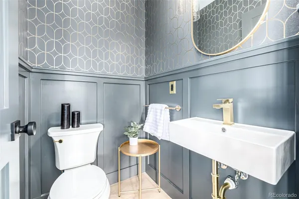 a bathroom with a sink mirror and toilet
