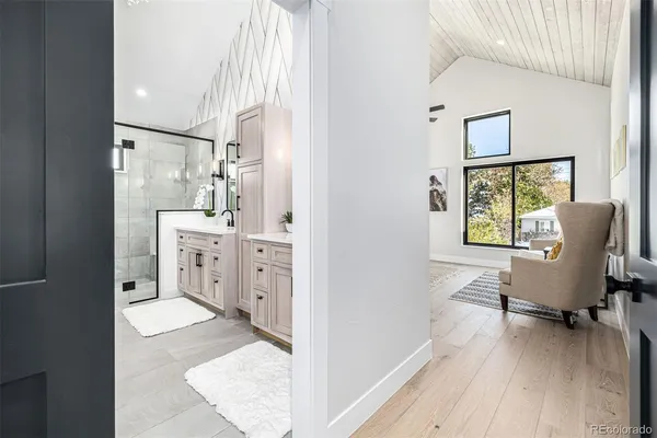 a spacious bathroom with a granite countertop sink mirror and shower