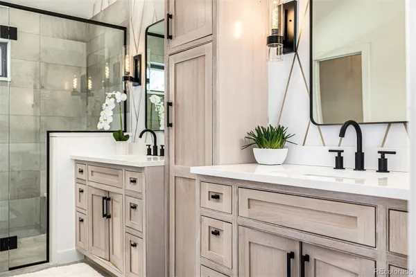 a spacious bathroom with a double vanity sink and mirror