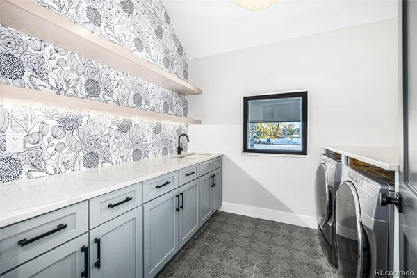 a view of a kitchen with sink and white cabinets