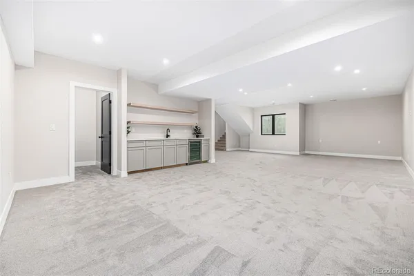 an empty room with a ceiling fan and window