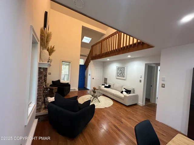 a living room with furniture or couch and a wooden floor