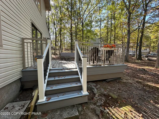 a view of a wooden chairs on the deck