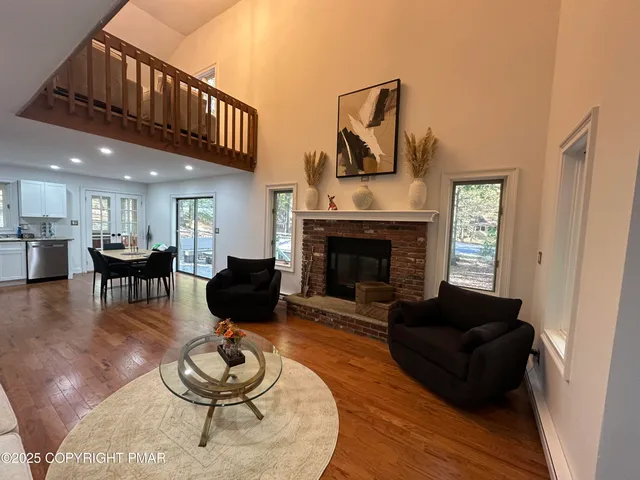 a living room with furniture fireplace and a window