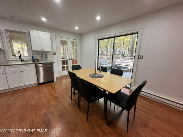 a view of a dining room with furniture window and wooden floor