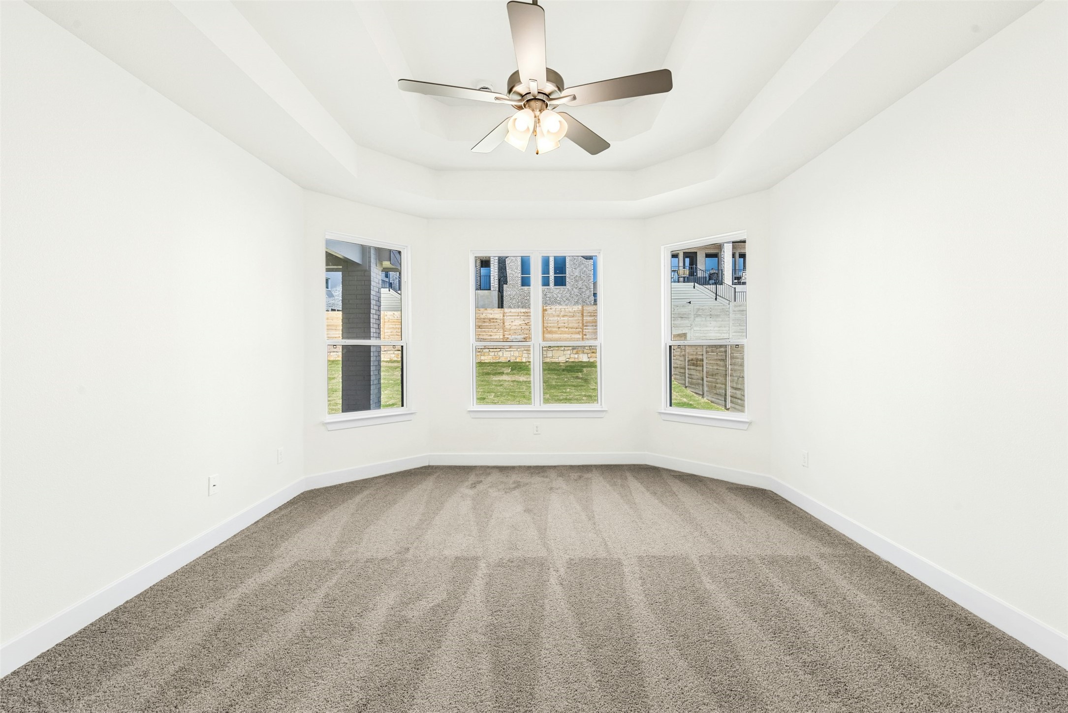 1520 Rodeo Ridge Drive Georgetown, TX 78628 - Photo 7 of 29 Carpeted empty room featuring a tray ceiling and a ceiling fan