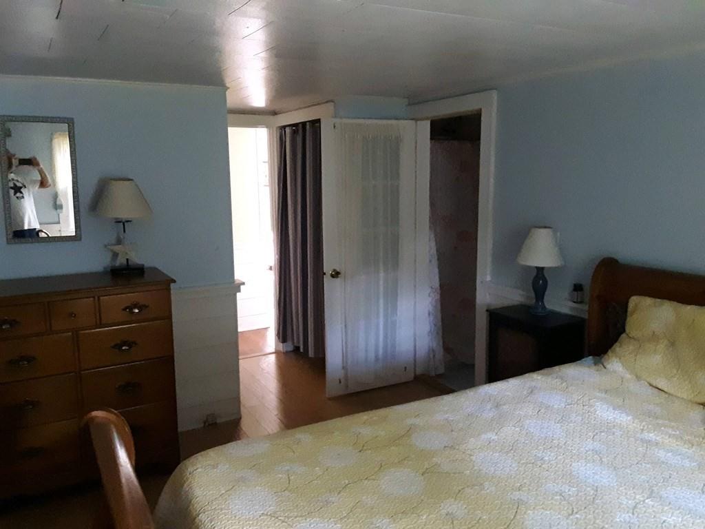 4 Hassan Road Dennis, MA 02639 - Photo 15 of 25 a bedroom with a bed and a dresser in it