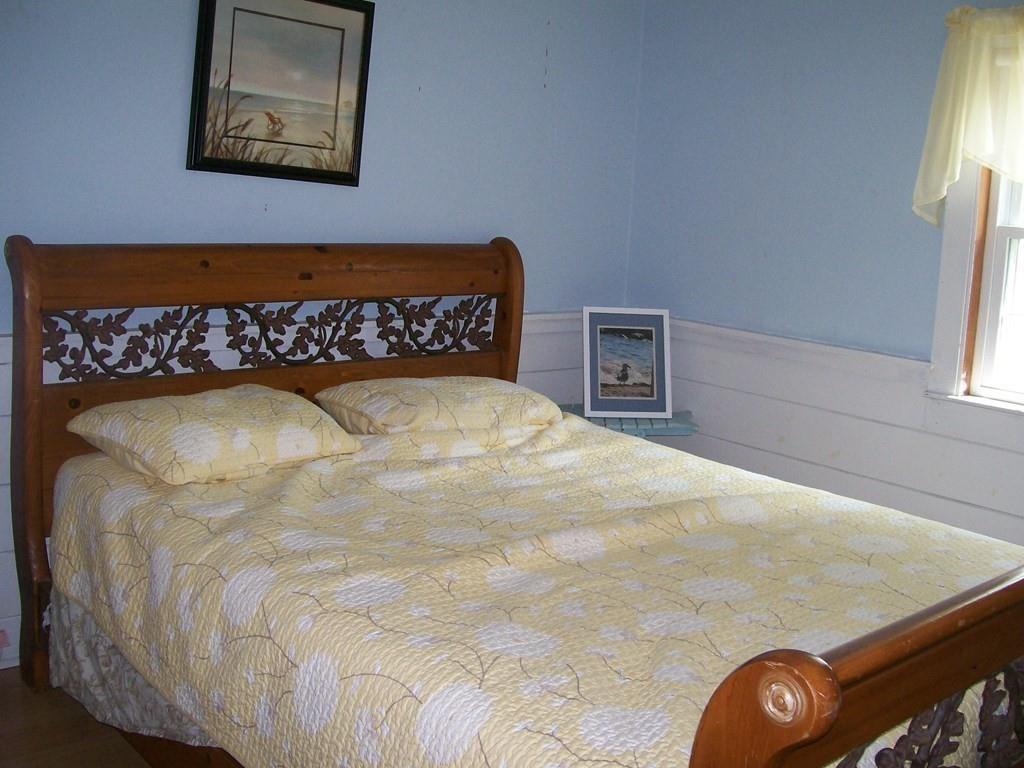 4 Hassan Road Dennis, MA 02639 - Photo 16 of 25 a bedroom with a bed and a painting on the wall