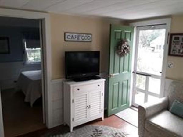 4 Hassan Road Dennis, MA 02639 - Photo 5 of 25 a living room with furniture and a flat screen tv