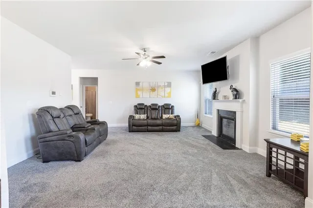a living room with furniture fireplace and flat screen tv