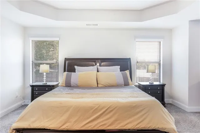 a bedroom with a large bed and wooden floor