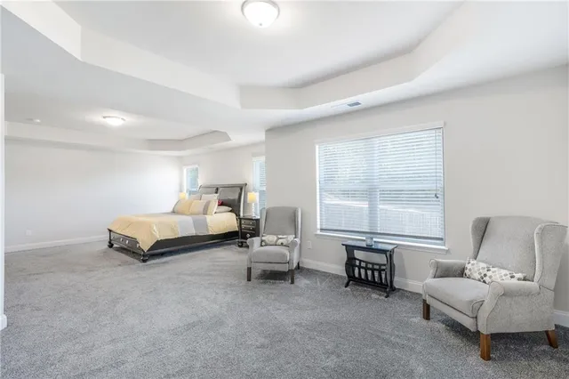 a spacious bedroom with a bed and a couch