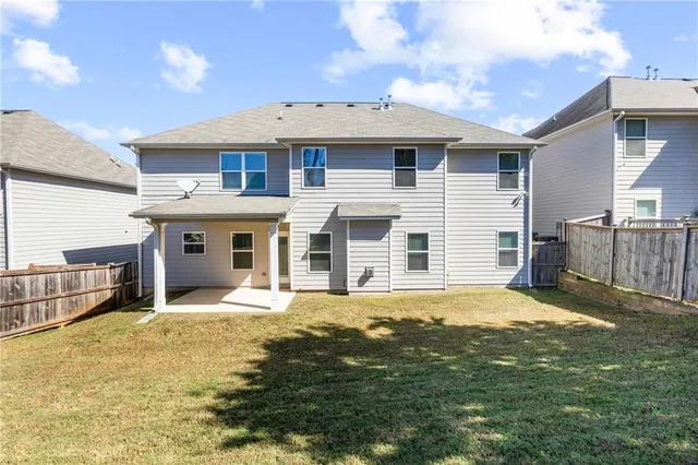 a view of a house with a swimming pool and a yard