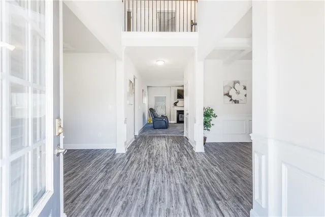 a view of a hallway with wooden floor and staircase