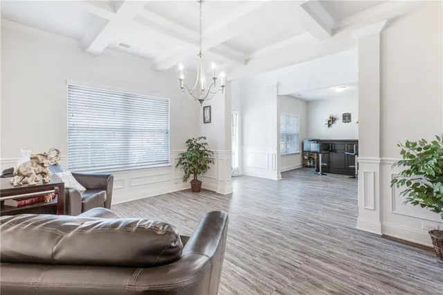 a living room with furniture and a chandelier