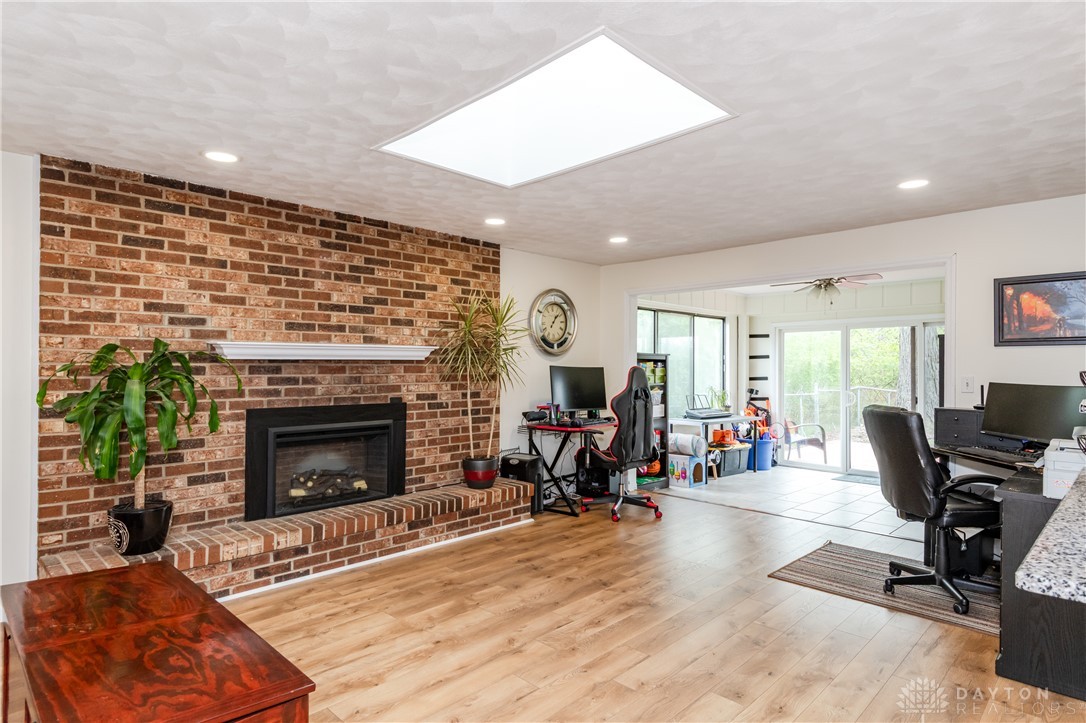 728 Chipplegate Drive Centerville, OH 45459 - Photo 8 of 30 This inviting living space features a warm brick fireplace, bright skylight, and sliding glass doors.