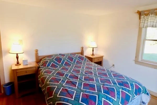 a bedroom with a bed and a lamp