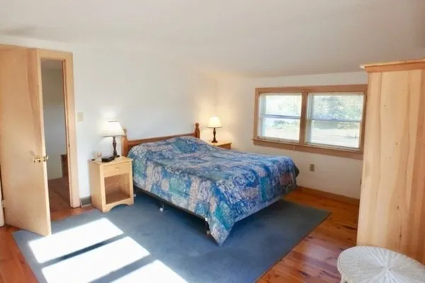 a bedroom with a bed and window