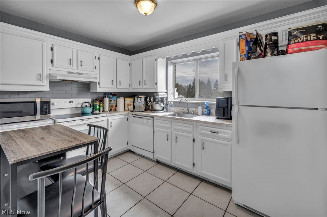 5200 Royalton Road, Unit 9B North Royalton, OH 44133 - Photo 13 of 27 Kitchen with white appliances, white cabinetry, and backsplash