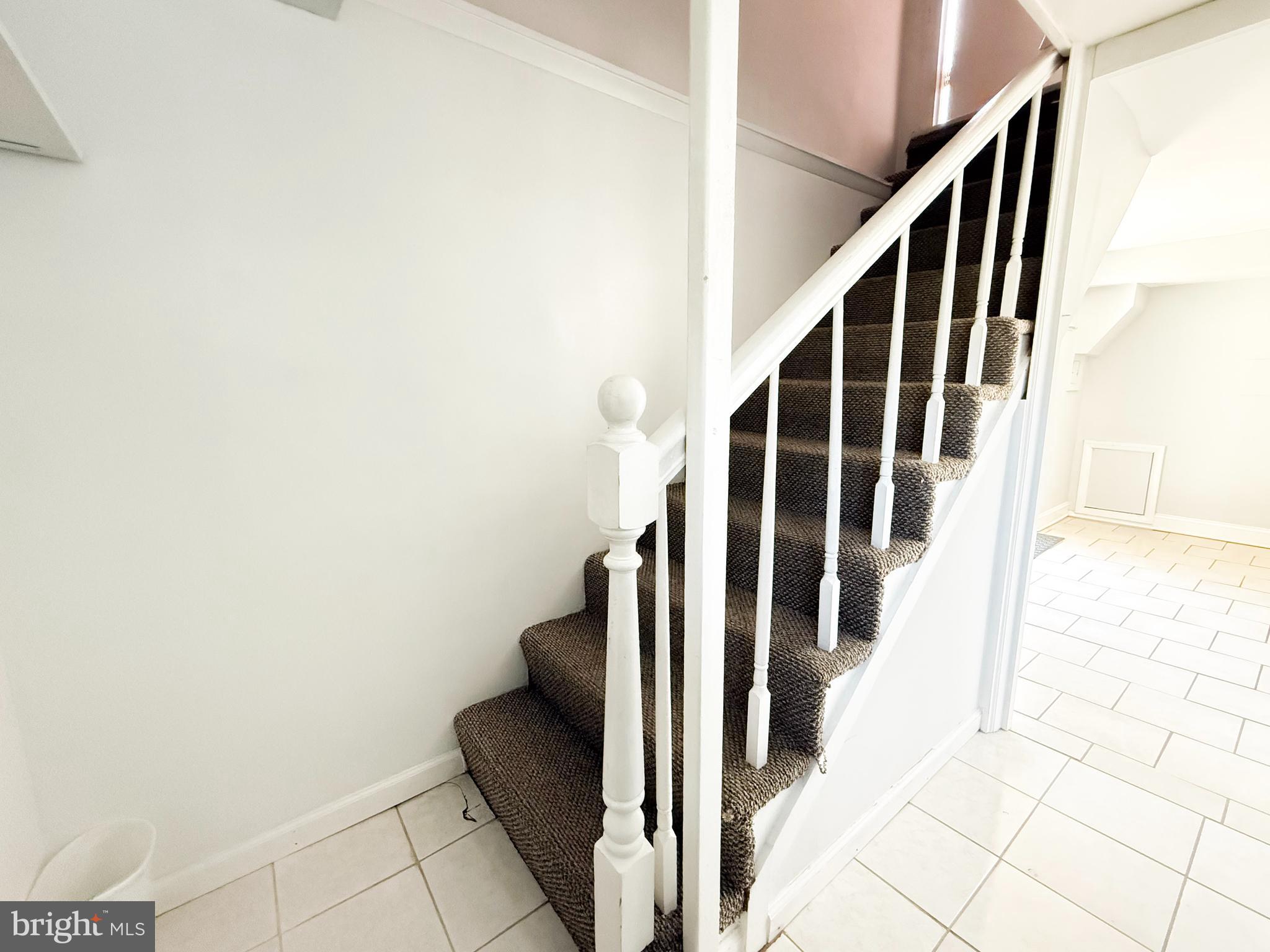 11601 Veirs Mill Road Wheaton, MD 20902 - Photo 15 of 30 a view of staircase with wooden floor and white walls